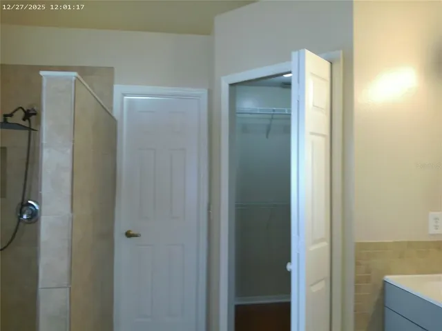 a bathroom with a shower and a mirror