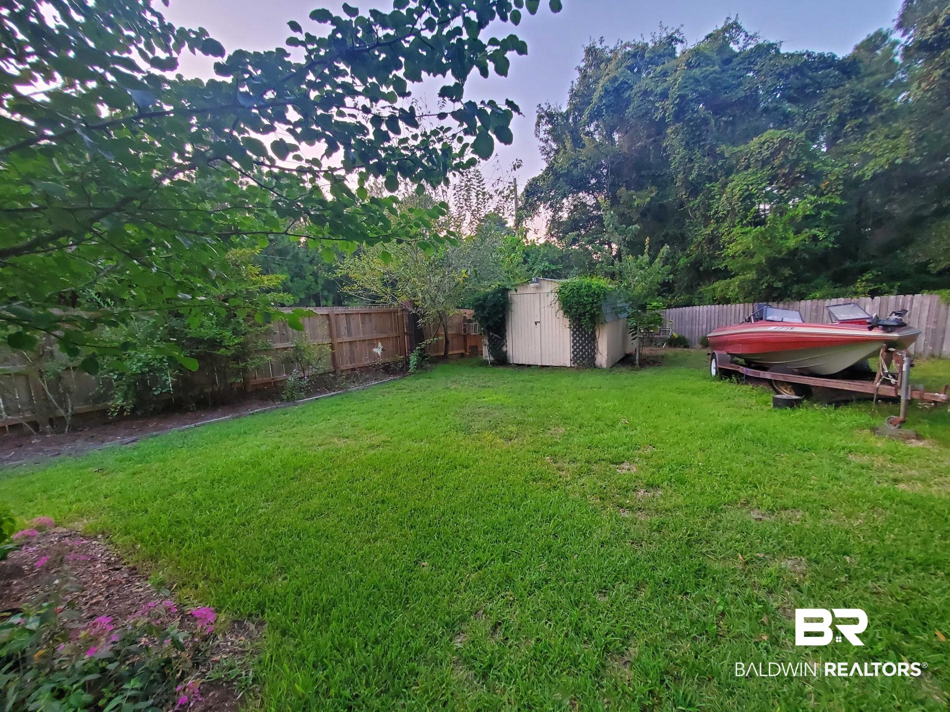 31163 Woodland Way Daphne, AL 36527 - Photo 39 of 44 Yard at dusk with a storage unit