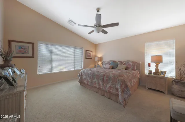 a spacious bedroom with a bed and window