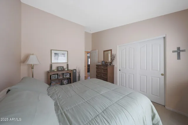 a bedroom with a bed and a chandelier
