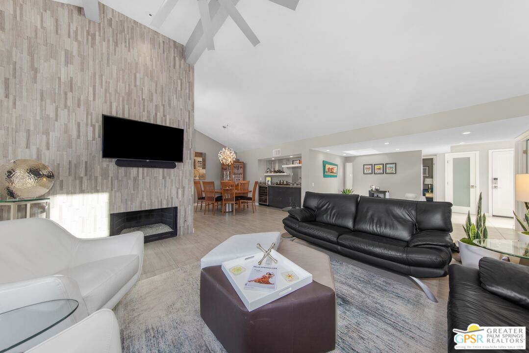 36022 Paseo Circulo West Cathedral City, CA 92234 - Photo 12 of 47 a living room with furniture a flat screen tv and a fireplace