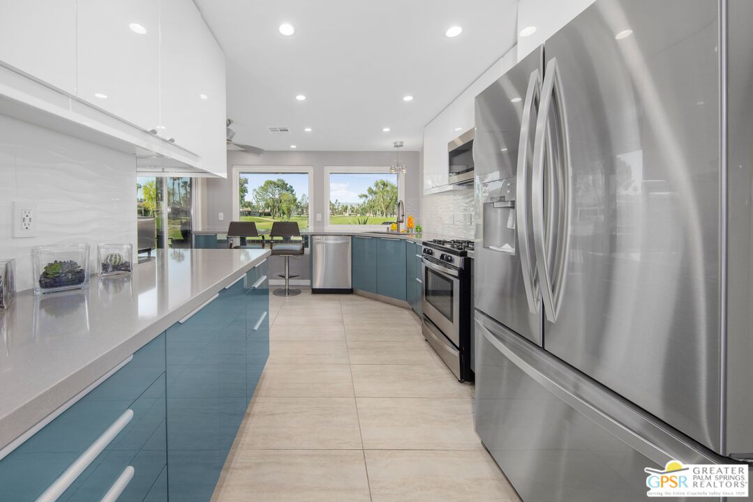 36022 Paseo Circulo West Cathedral City, CA 92234 - Photo 14 of 47 a large white kitchen with a large window