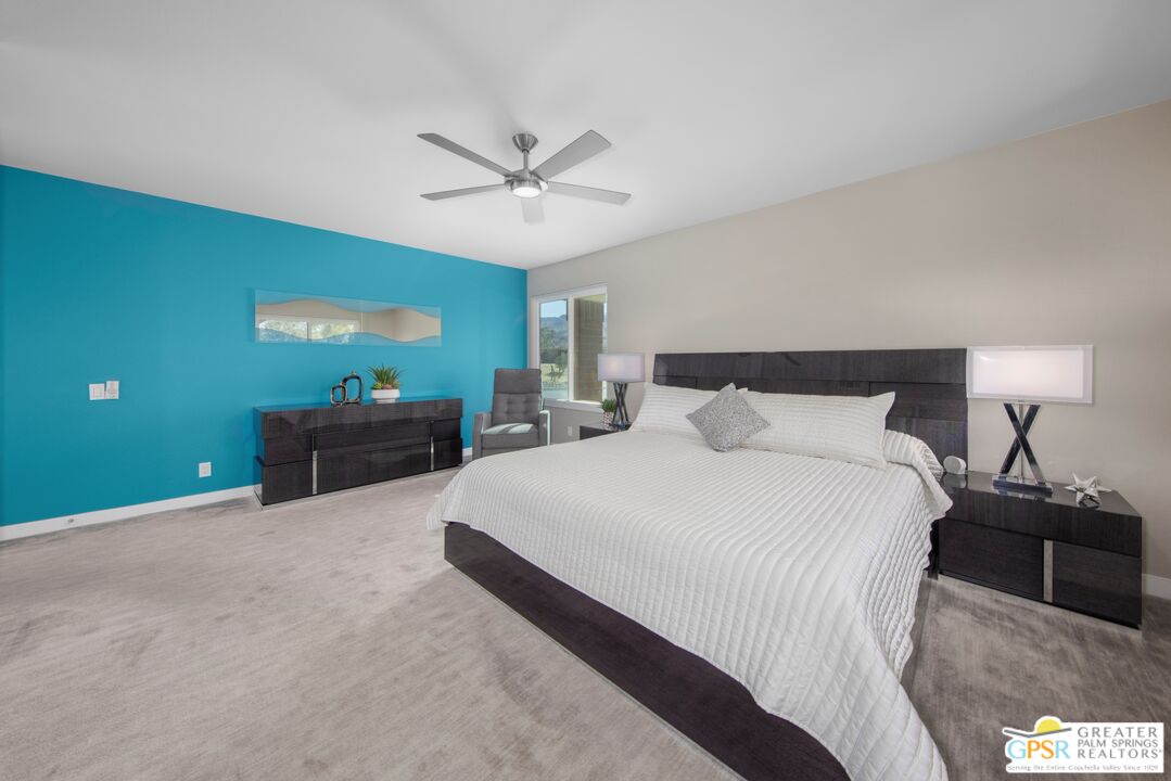 36022 Paseo Circulo West Cathedral City, CA 92234 - Photo 19 of 47 a bedroom with a bed and a chandelier