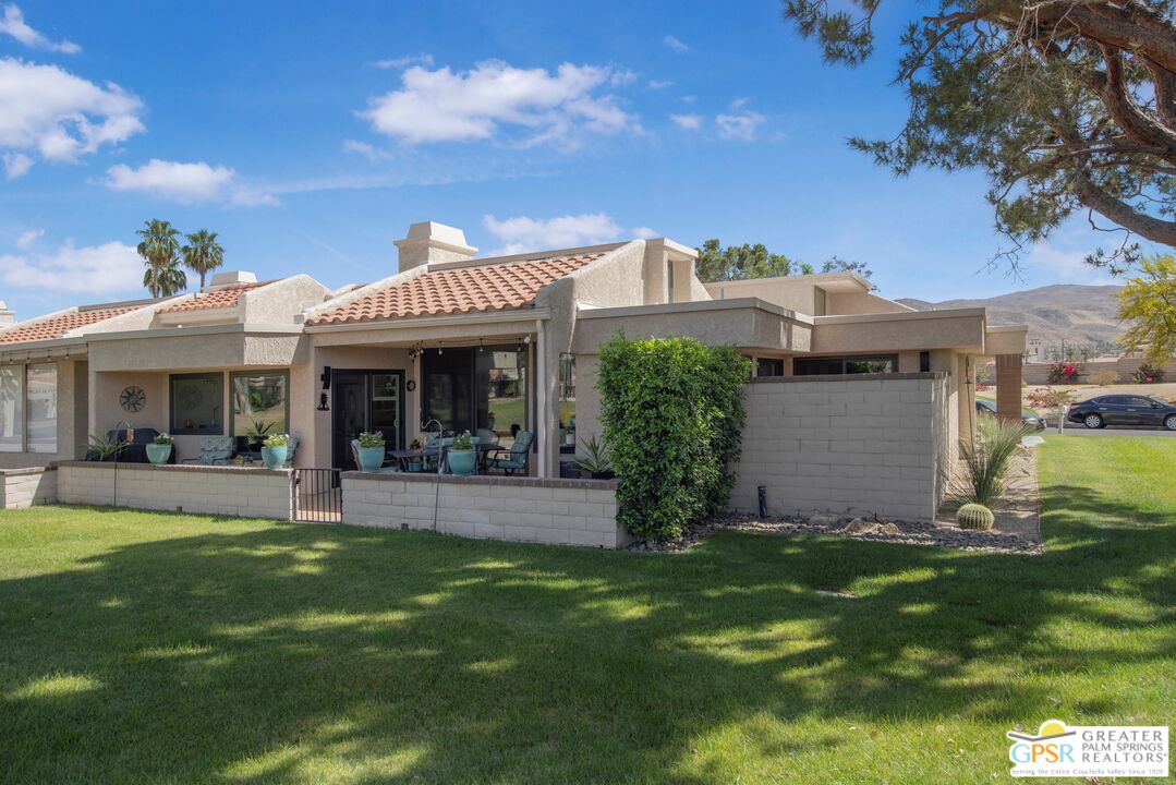36022 Paseo Circulo West Cathedral City, CA 92234 - Photo 2 of 47 a front view of a house with garden and porch