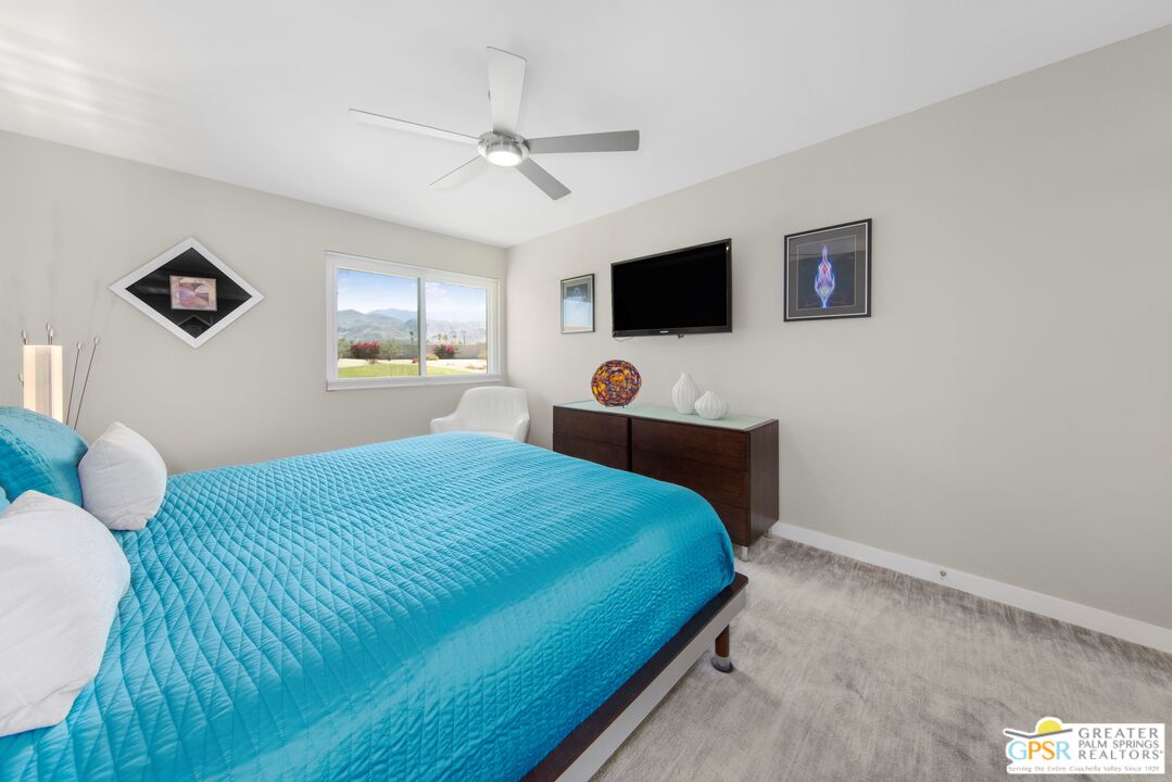 36022 Paseo Circulo West Cathedral City, CA 92234 - Photo 28 of 47 a bedroom with a bed and a flat screen tv