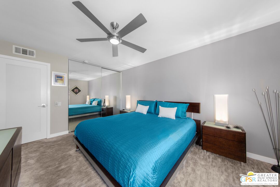 36022 Paseo Circulo West Cathedral City, CA 92234 - Photo 29 of 47 a bedroom with a bed and a chandelier