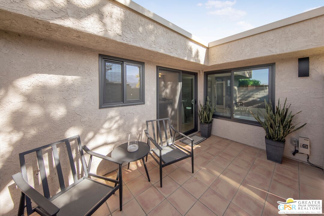36022 Paseo Circulo West Cathedral City, CA 92234 - Photo 36 of 47 a view of a porch with chairs and potted plants