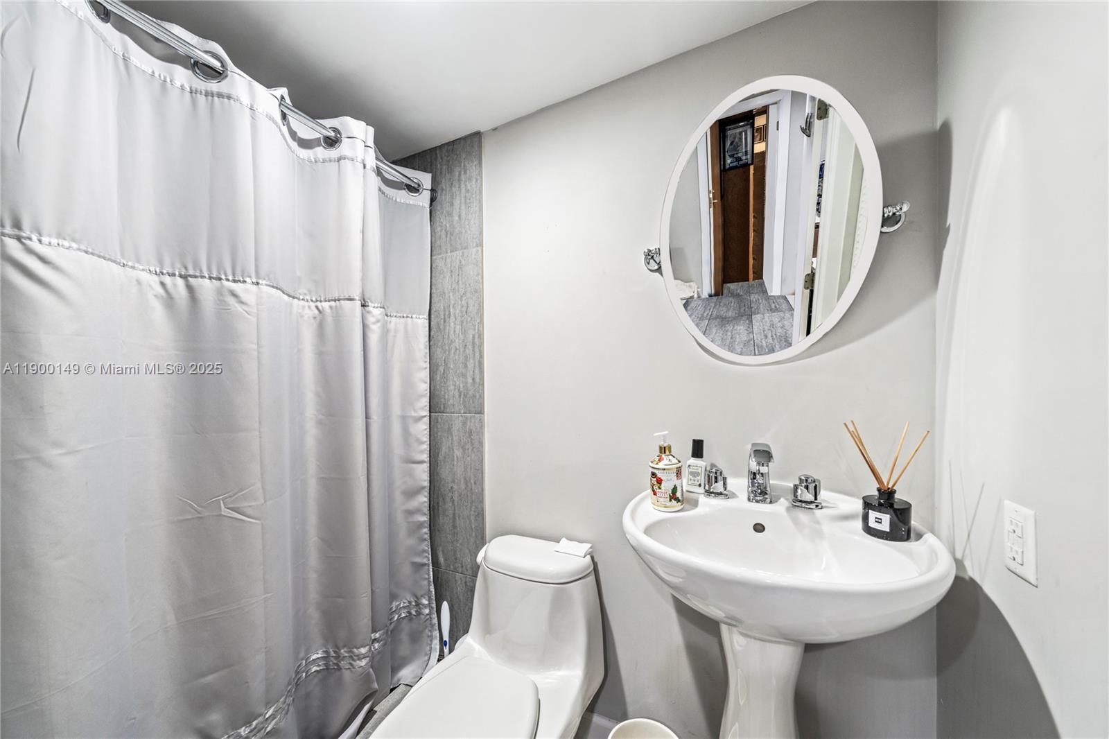 5820 Palm Tree Road Plantation, FL 33317 - Photo 17 of 23 a bathroom with a sink a toilet and shower curtain