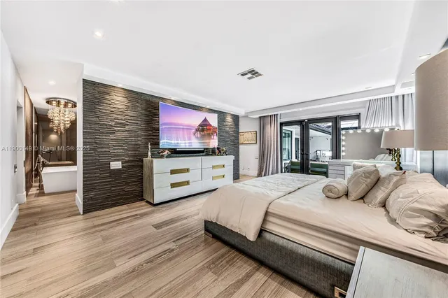 a bedroom with a bed and a flat screen tv