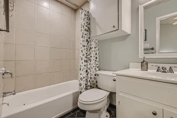 a bathroom with a sink toilet vanity and shower