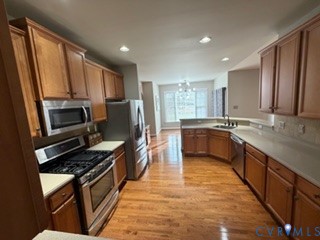 1406 Lundy Terrace Midlothian, VA 23114 - Photo 12 of 37 a kitchen with stainless steel appliances a sink stove and cabinets