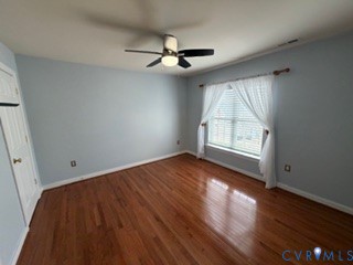 1406 Lundy Terrace Midlothian, VA 23114 - Photo 19 of 37 an empty room with wooden floor chandelier fan and windows