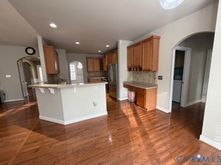1406 Lundy Terrace Midlothian, VA 23114 - Photo 10 of 37 a kitchen with kitchen island stainless steel appliances a sink cabinets and a counter top space