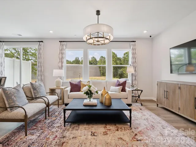 a dining room with furniture window and wooden floor
