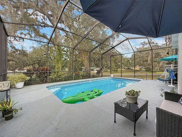 a view of a swimming pool with a patio