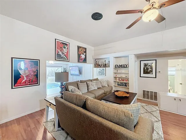a living room with furniture a couch and a window