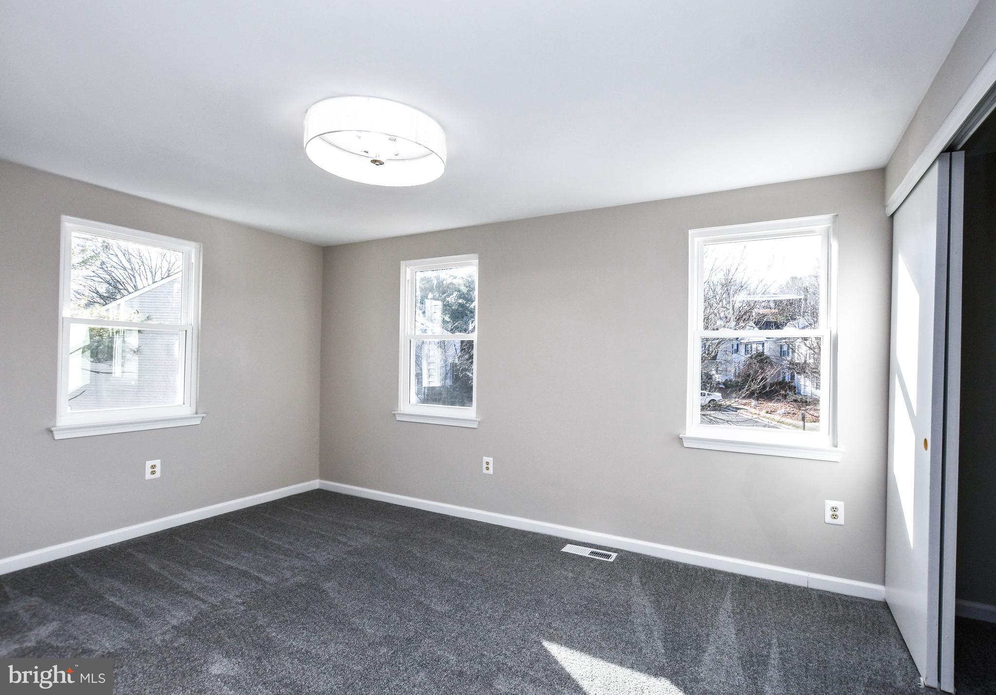 9 Dorrell Court Sterling, VA 20165 - Photo 24 of 36 a view of an empty room with a window and wooden floor