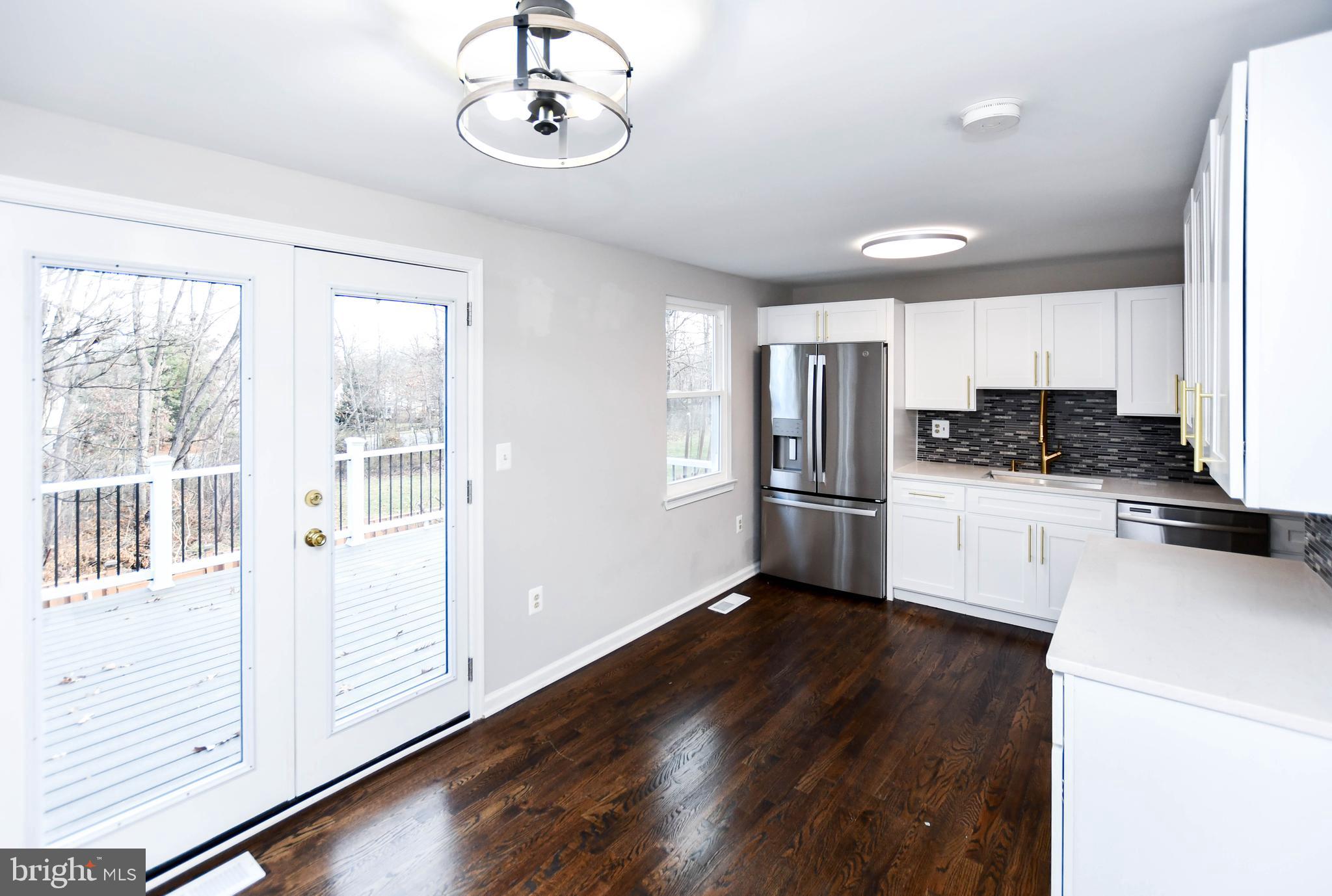 9 Dorrell Court Sterling, VA 20165 - Photo 10 of 36 a kitchen with stainless steel appliances a refrigerator and a stove top oven