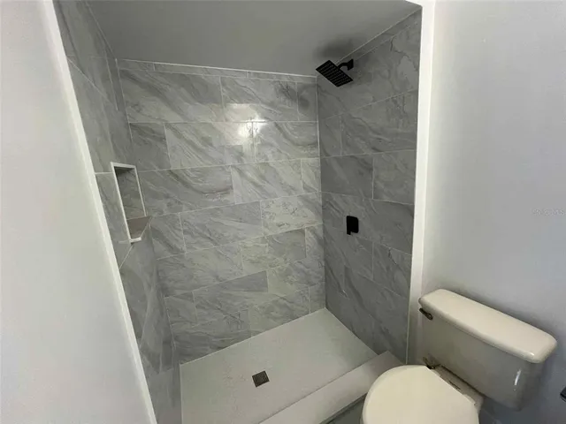 a bathroom with a shower and toilet