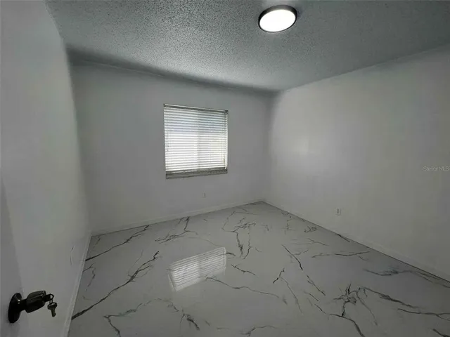 an empty room with a empty space and windows