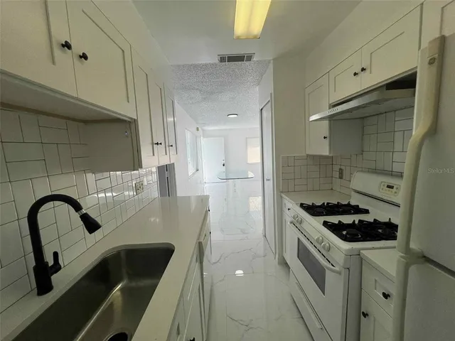 a view of a sink and dishwasher in a kitchen