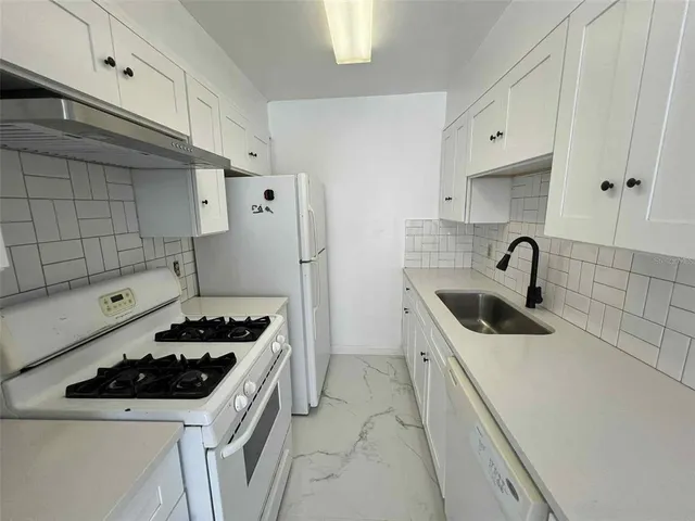 a kitchen that has a sink and a stove