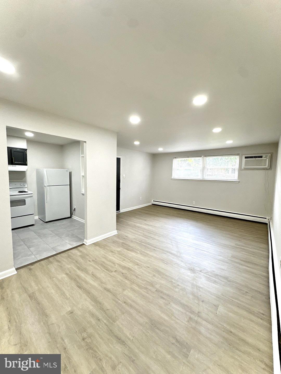 521 Martin Street, Unit A1 Philadelphia, PA 19128 - Photo 2 of 6 a view of an empty room with window and wooden floor