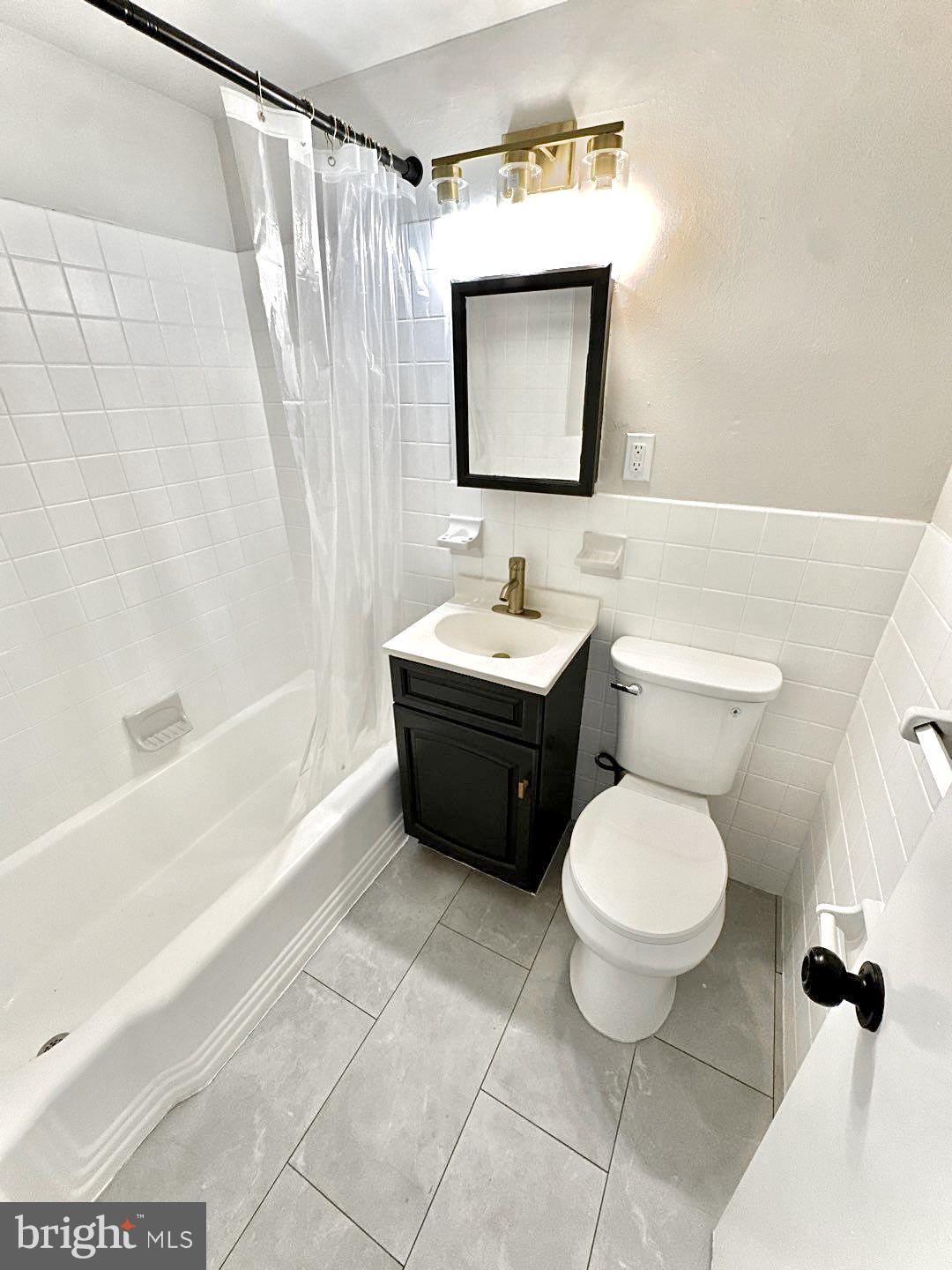 521 Martin Street, Unit A1 Philadelphia, PA 19128 - Photo 6 of 6 a bathroom with a toilet sink and mirror