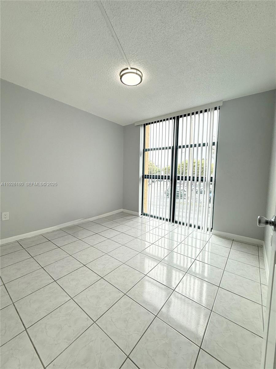 11790 Southwest 18th Street, Unit 2193 Miami, FL 33175 - Photo 12 of 13 a view of an empty room and a window