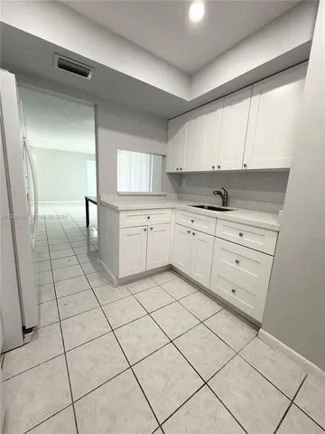 a kitchen with a cabinets and window