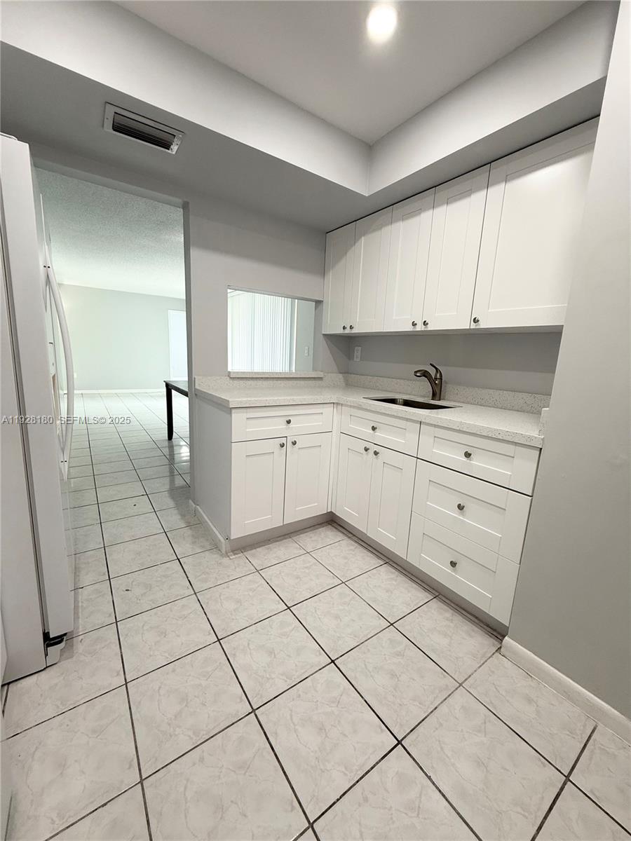 11790 Southwest 18th Street, Unit 2193 Miami, FL 33175 - Photo 2 of 13 a kitchen with a cabinets and window