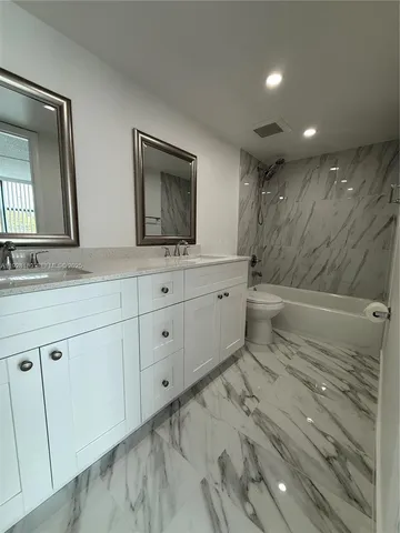 a bathroom with a sink a mirror and a toilet