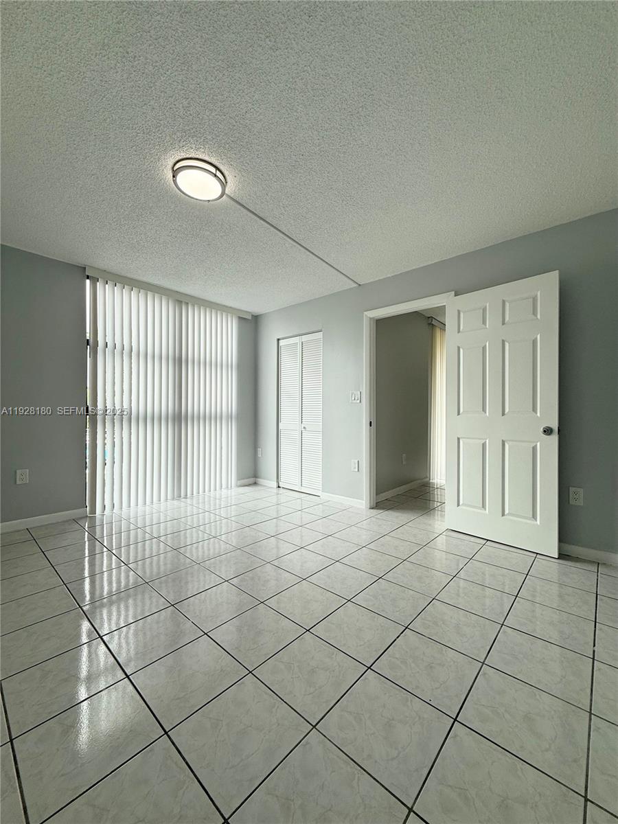 11790 Southwest 18th Street, Unit 2193 Miami, FL 33175 - Photo 5 of 13 a view of an empty room and window