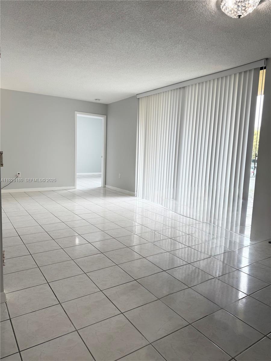 11790 Southwest 18th Street, Unit 2193 Miami, FL 33175 - Photo 8 of 13 a view of a livingroom with an empty space and a window