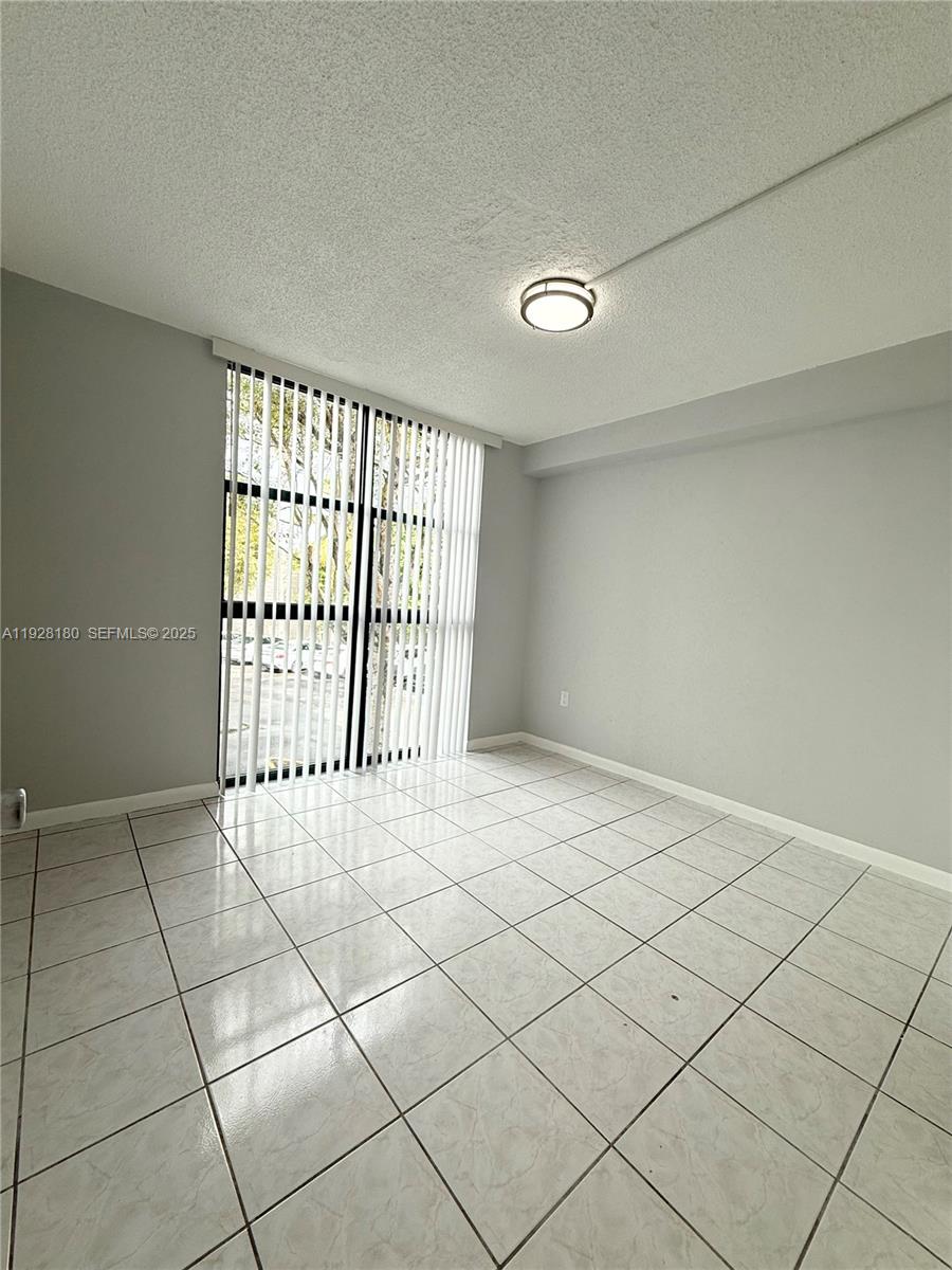 11790 Southwest 18th Street, Unit 2193 Miami, FL 33175 - Photo 10 of 13 a view of an empty room with a window