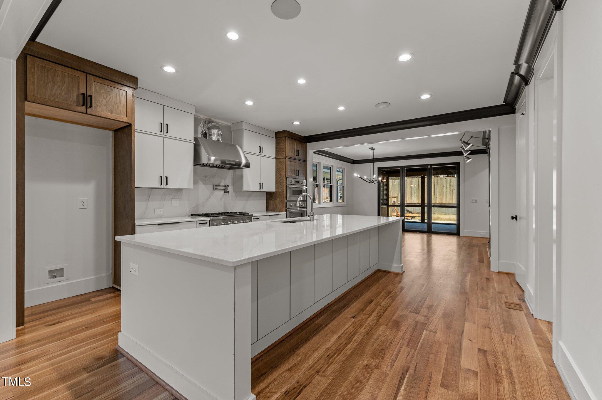 1437 Nottingham Road Raleigh, NC 27607 - Photo 14 of 61 a large kitchen with stainless steel appliances a large counter top a stove and a refrigerator