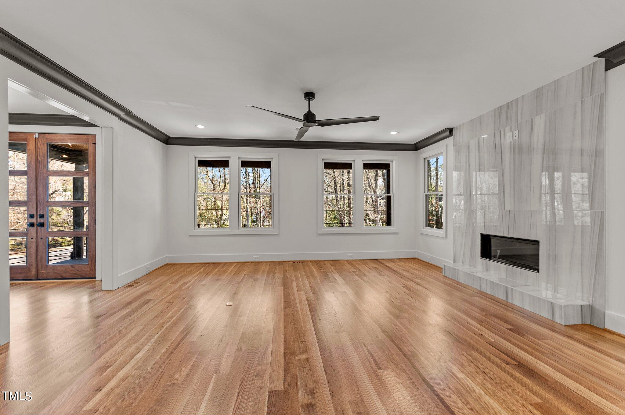 1437 Nottingham Road Raleigh, NC 27607 - Photo 15 of 61 wooden floor in an empty room with a fireplace