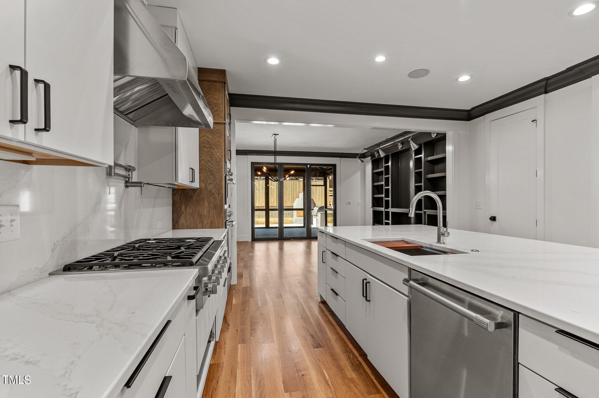 1437 Nottingham Road Raleigh, NC 27607 - Photo 17 of 61 a kitchen with stainless steel appliances granite countertop a sink stove and cabinets