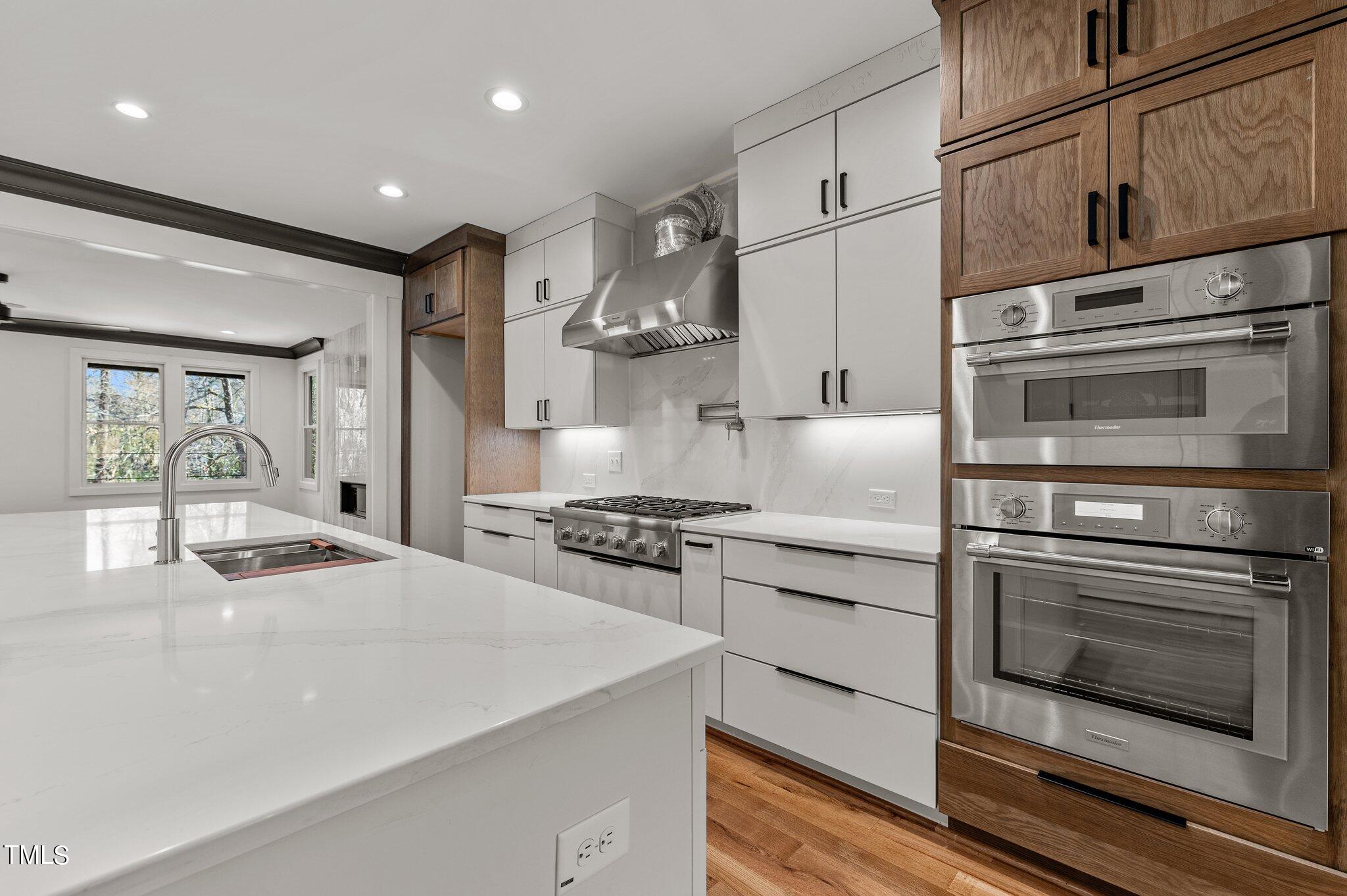 1437 Nottingham Road Raleigh, NC 27607 - Photo 18 of 61 a kitchen with stainless steel appliances granite countertop a stove and a refrigerator