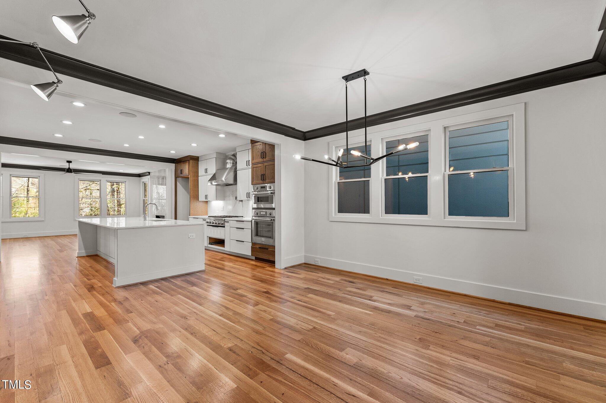 1437 Nottingham Road Raleigh, NC 27607 - Photo 19 of 61 a view of an empty room with wooden floor and a window