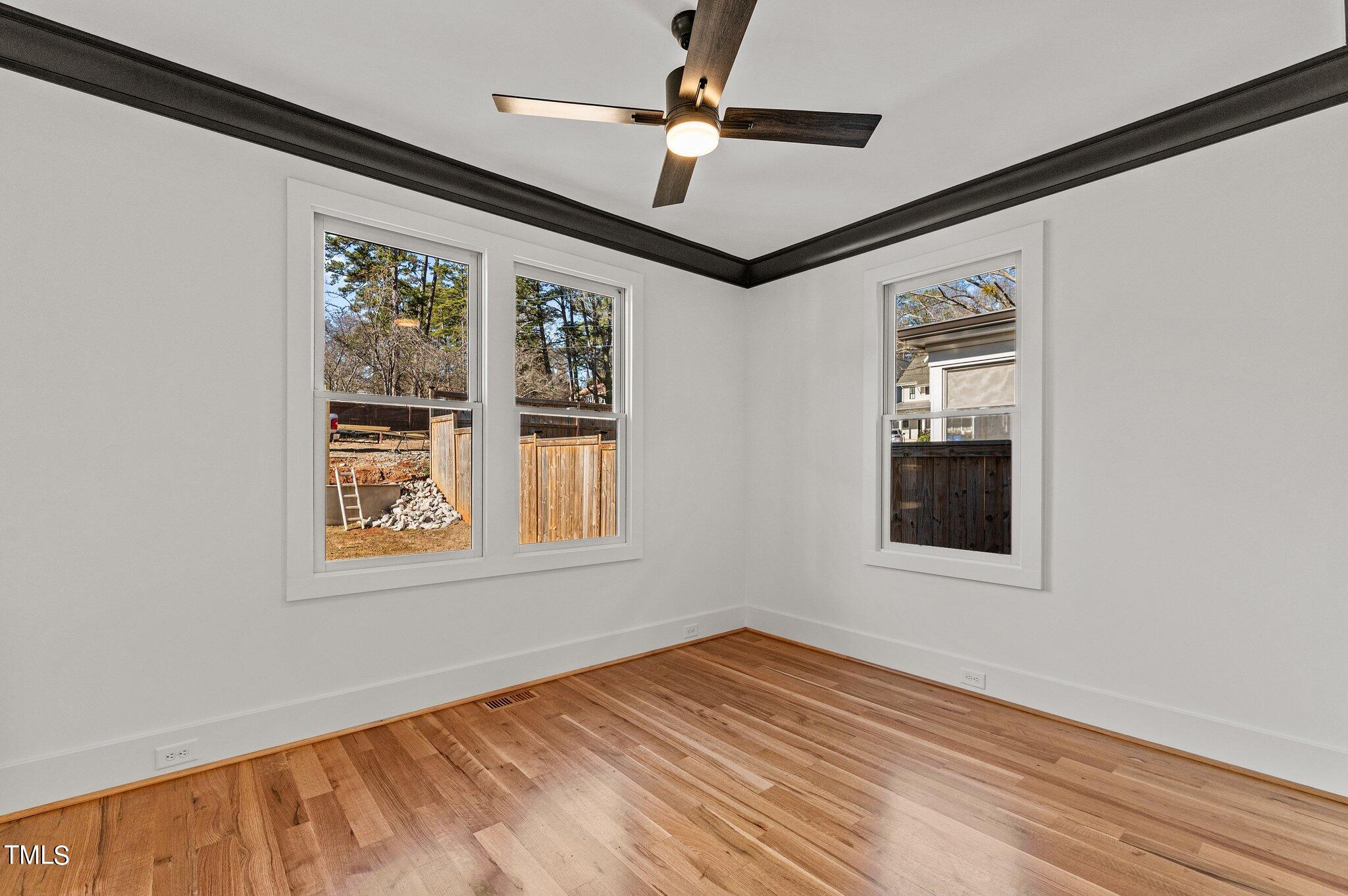 1437 Nottingham Road Raleigh, NC 27607 - Photo 21 of 61 a view of an empty room with a window and wooden floor