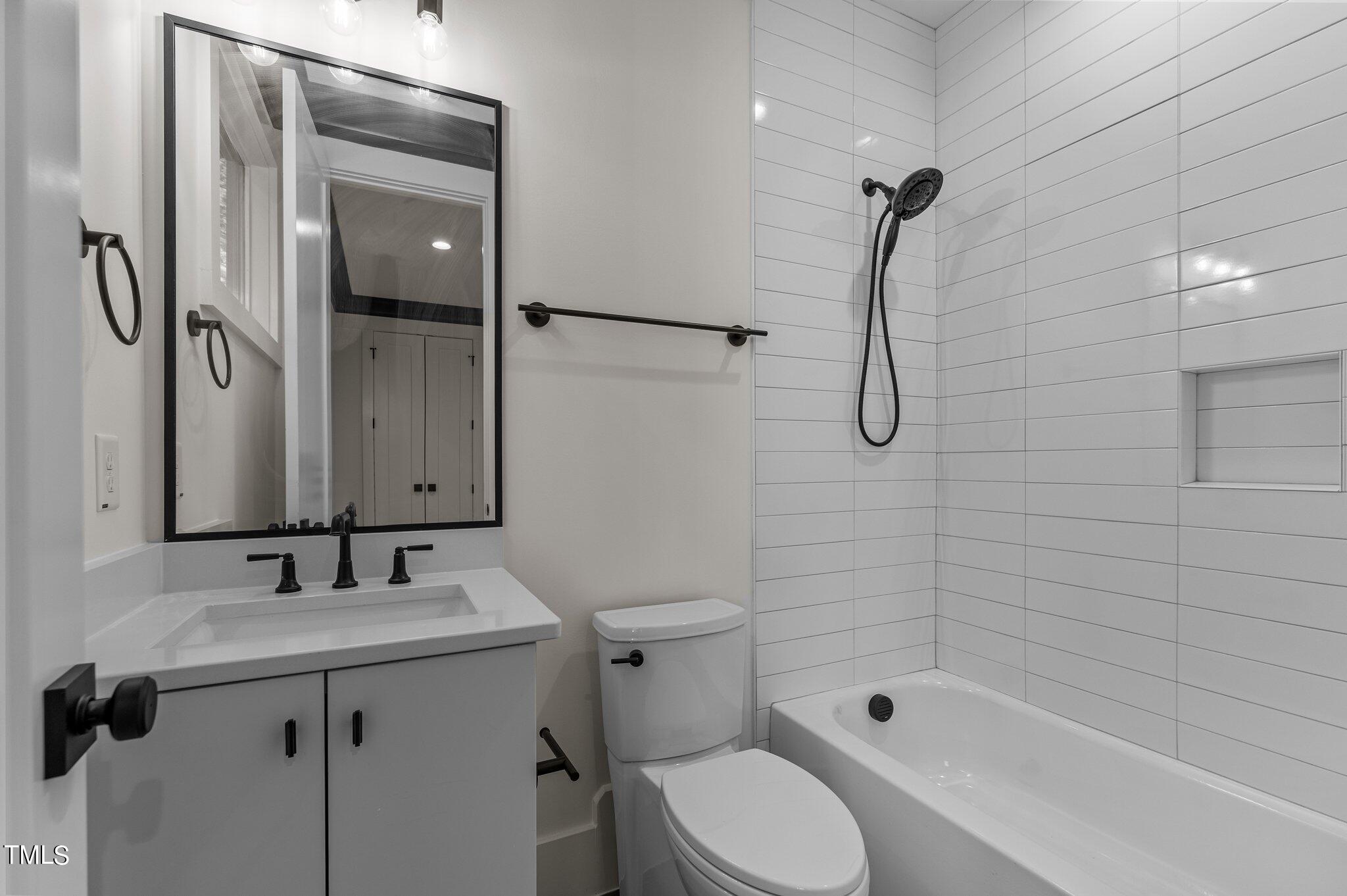 1437 Nottingham Road Raleigh, NC 27607 - Photo 23 of 61 a bathroom with a shower sink vanity mirror and toilet