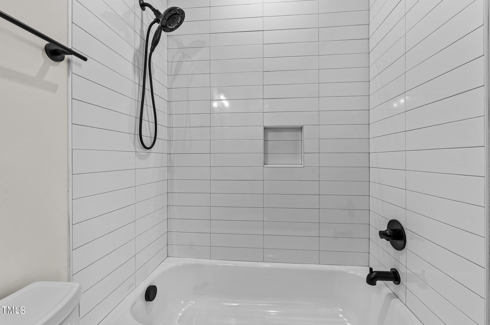 1437 Nottingham Road Raleigh, NC 27607 - Photo 24 of 61 a bathroom with a shower and a bathtub