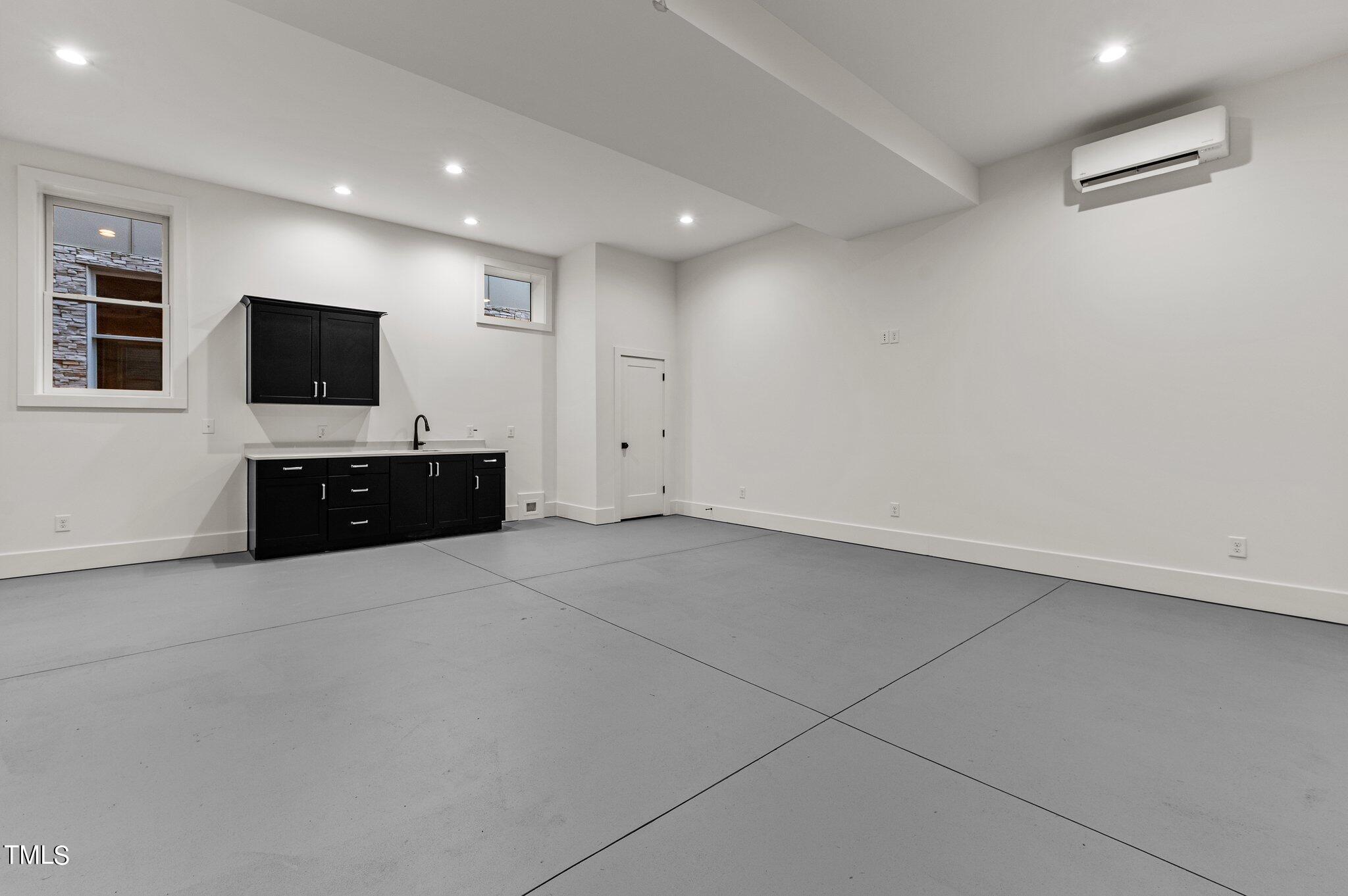 1437 Nottingham Road Raleigh, NC 27607 - Photo 27 of 61 an empty room with flat screen tv and windows