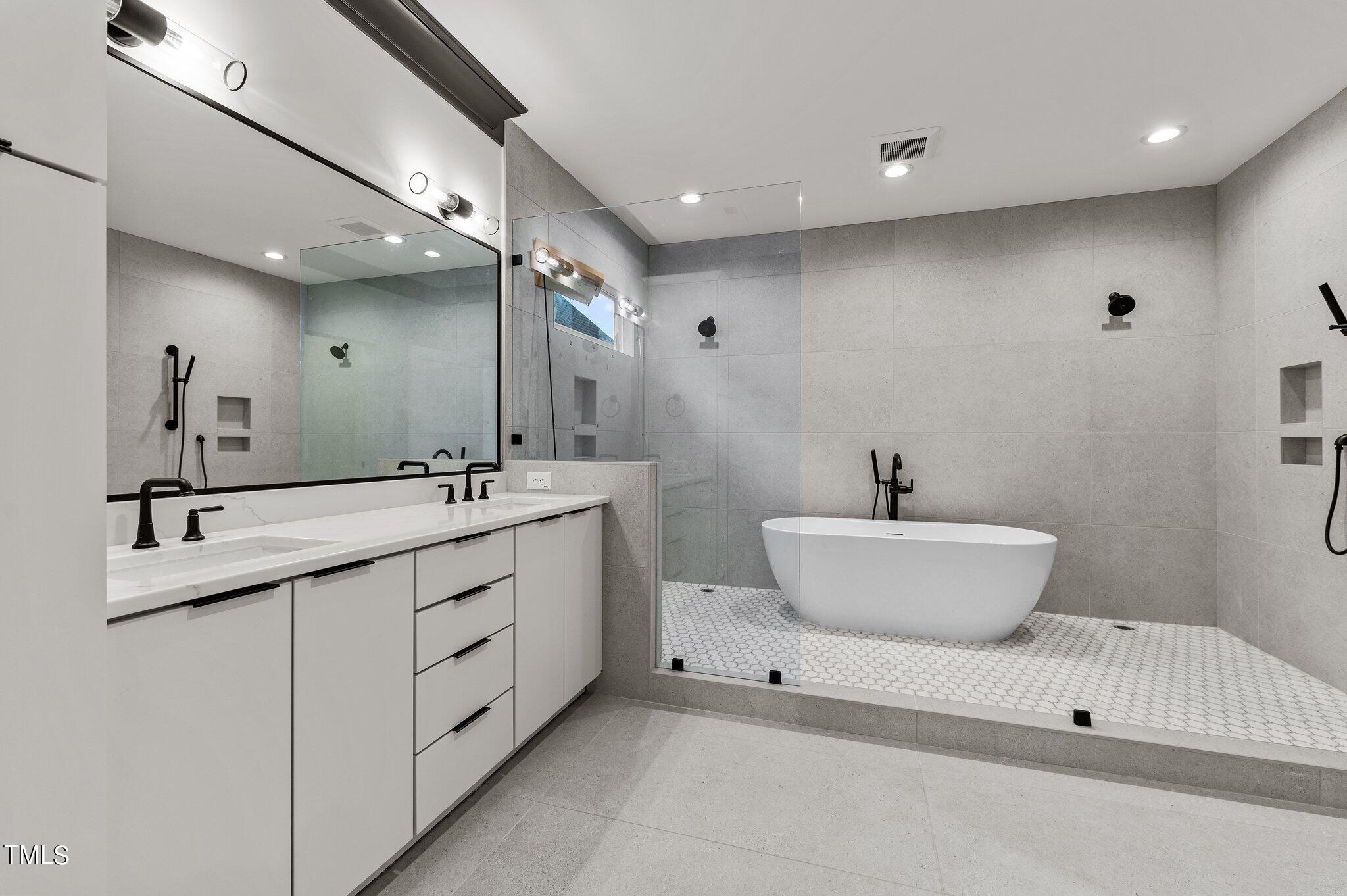 1437 Nottingham Road Raleigh, NC 27607 - Photo 37 of 61 a bathroom with a white tub sink and mirror