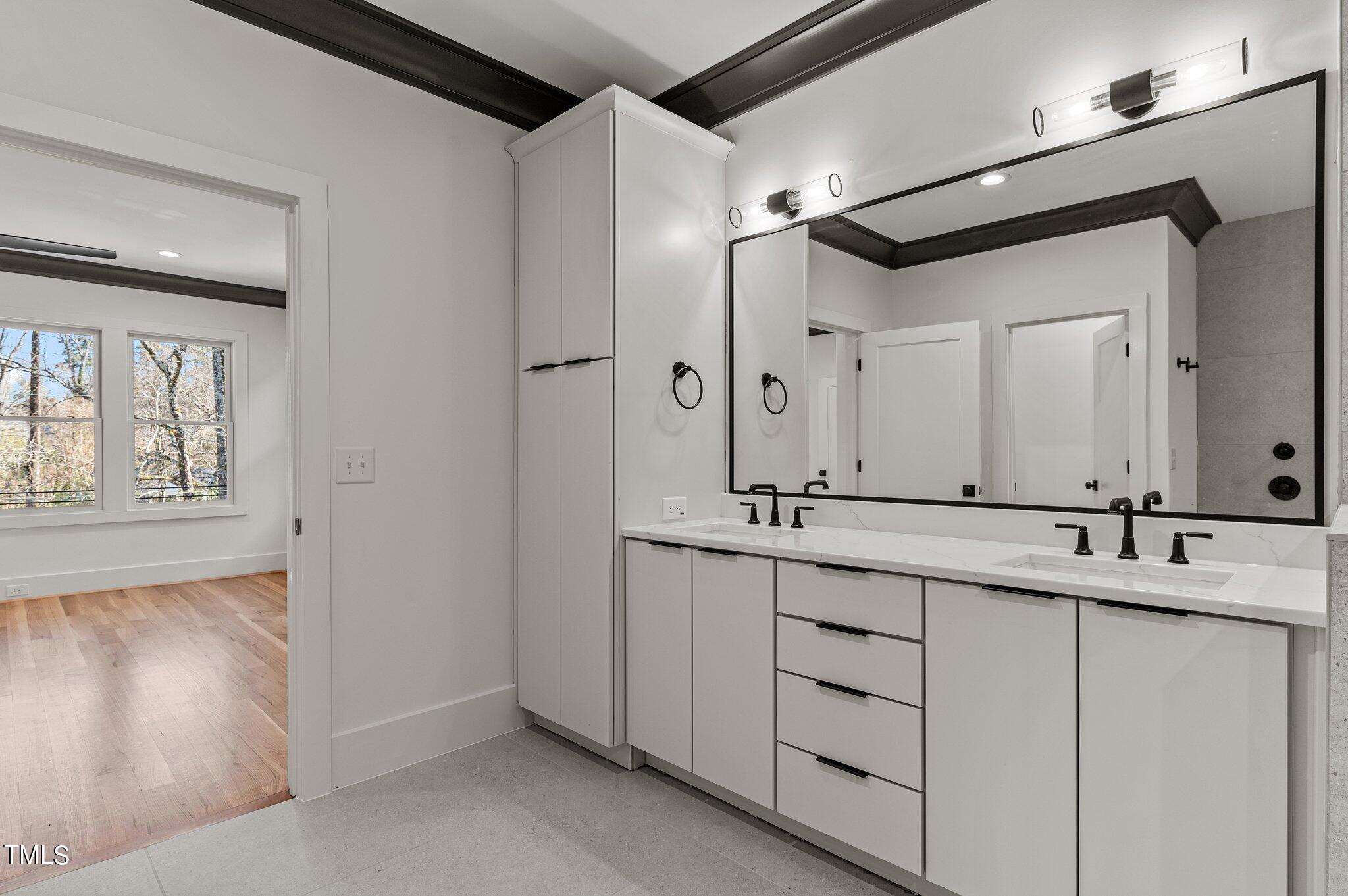 1437 Nottingham Road Raleigh, NC 27607 - Photo 39 of 61 a bathroom with a double vanity sink and mirror with bathtub