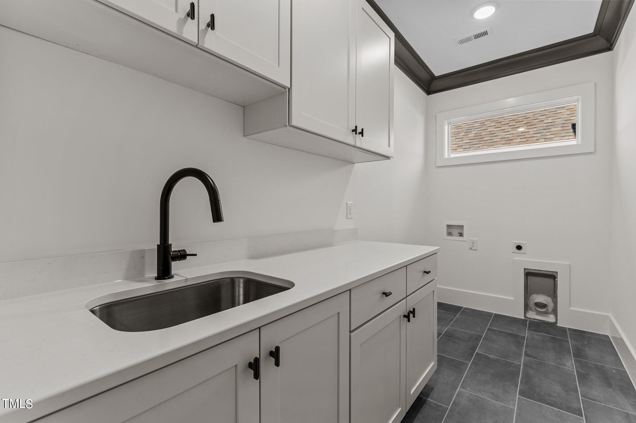 1437 Nottingham Road Raleigh, NC 27607 - Photo 41 of 61 a kitchen with a sink and cabinets