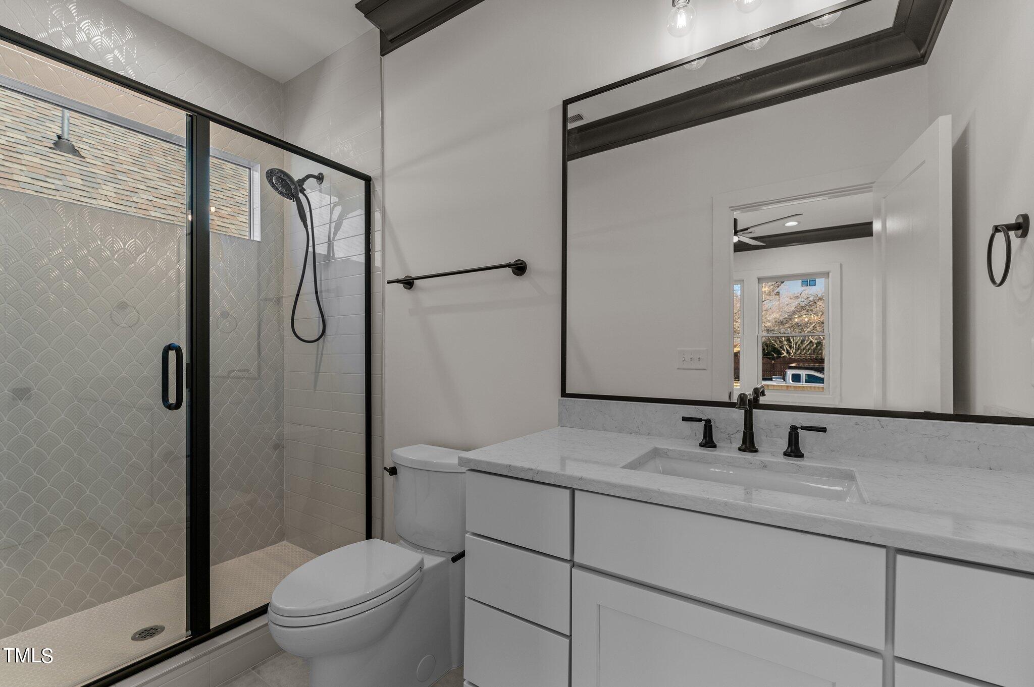 1437 Nottingham Road Raleigh, NC 27607 - Photo 46 of 61 a bathroom with a granite countertop sink toilet mirror and shower