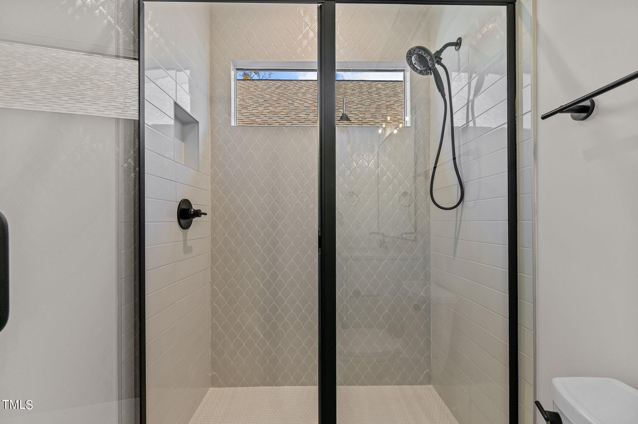 1437 Nottingham Road Raleigh, NC 27607 - Photo 47 of 61 a bathroom with a glass shower door