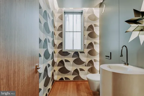 a bathroom with a sink and mirror with painted walls
